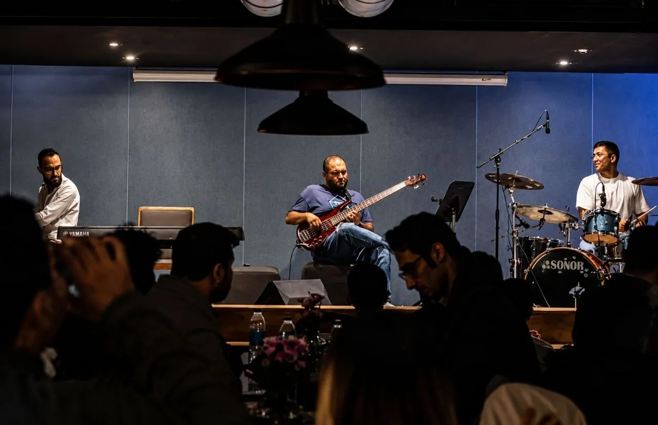 Jazz-club trio with audience in the foreground