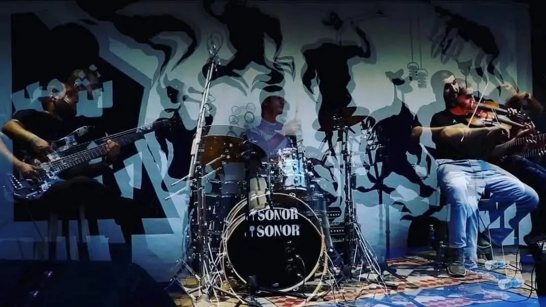 Blue duotone band shot against a mural