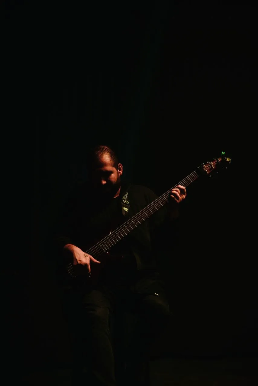 Low-key portrait, hands emerging from darkness