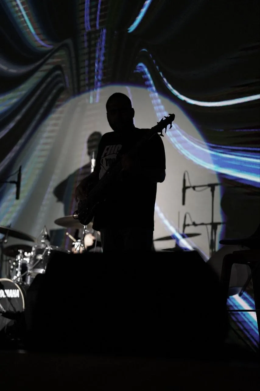 Silhouette against a swirling blue projection