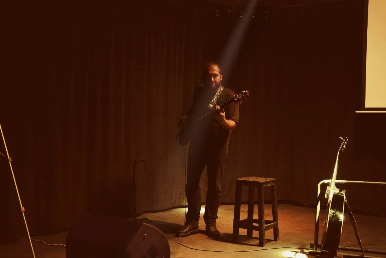 Alone in a single warm beam on an empty stage
