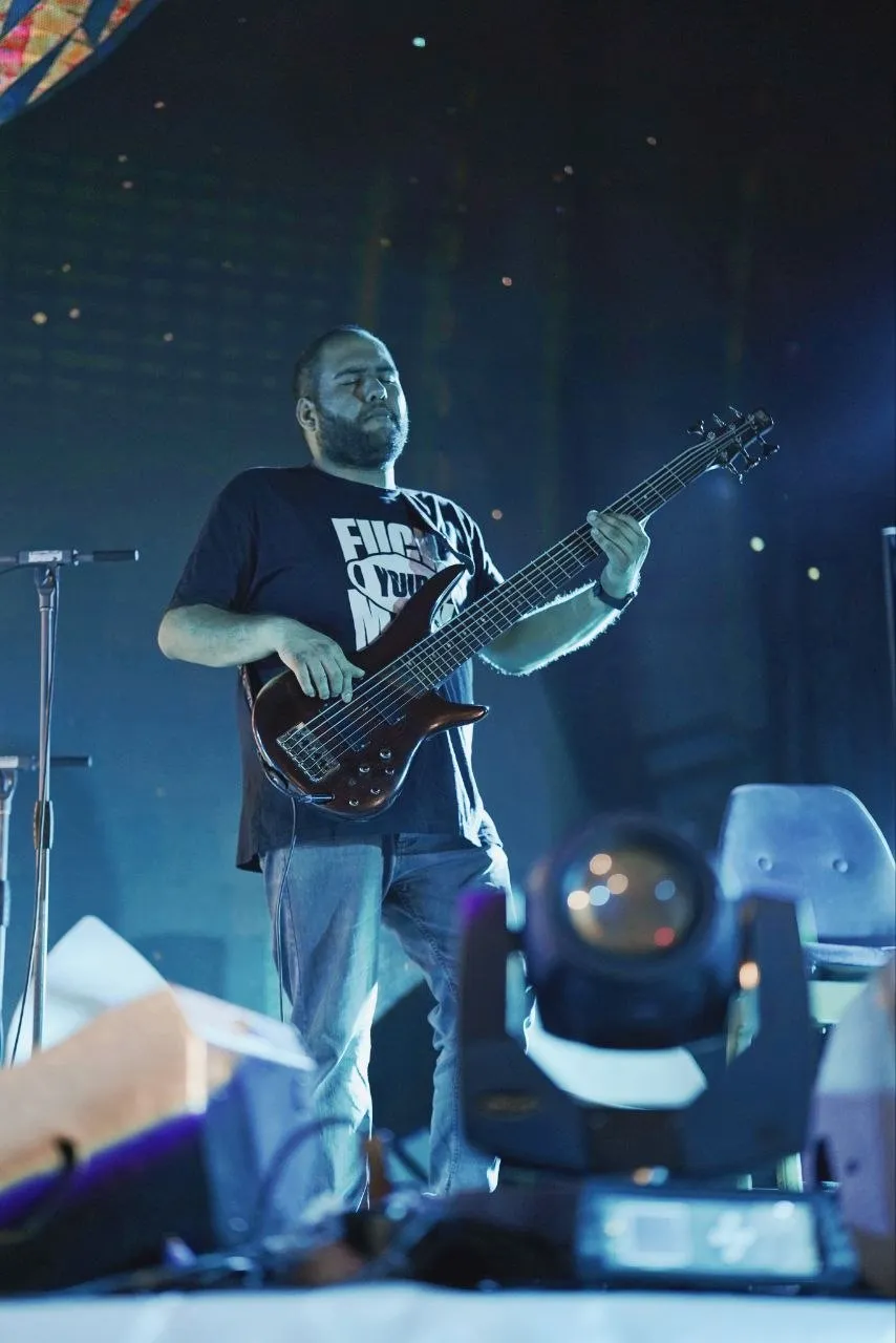 Playing on a large blue-lit stage